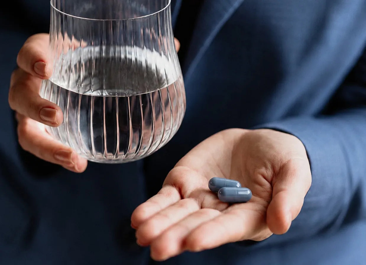 Creatine powder being scooped into a glass of water